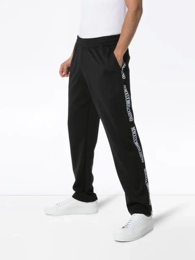 Shop Moschino Logo-stripe Track Pants In Black