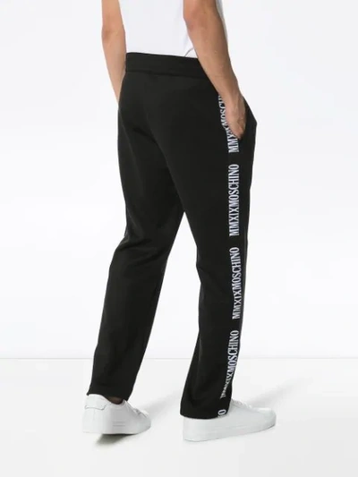 Shop Moschino Logo-stripe Track Pants In Black