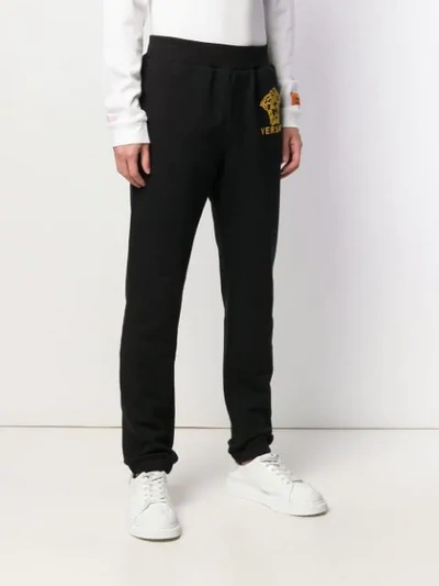 Shop Versace Gold-tone Logo Track Pants In Black