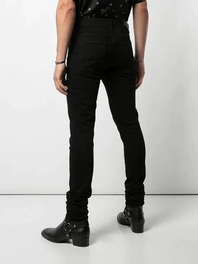 Shop Amiri Skinny Jeans - Black