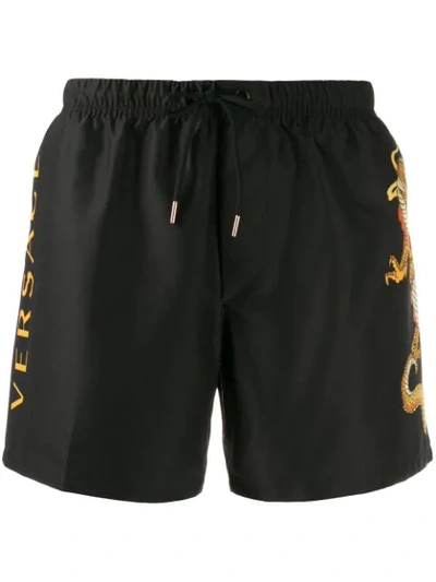 Shop Versace Dragon Motif Swim Shorts In Black