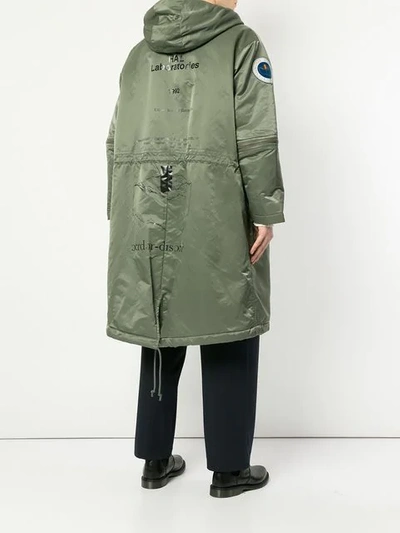 Shop Undercover Oversized Hooded Parka In Green