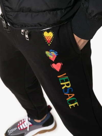 Shop Versace Heart-embroidered Track Trousers In Black