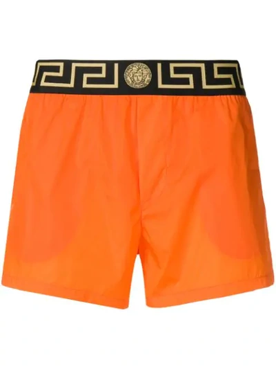 Shop Versace Greek Keys Swim Shorts In Orange