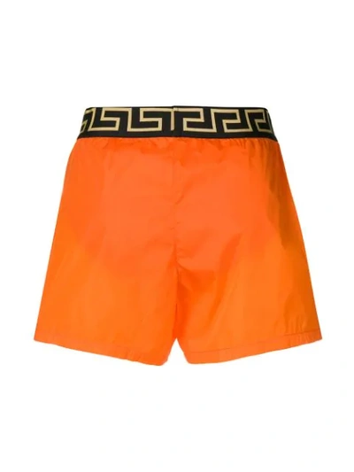 Shop Versace Greek Keys Swim Shorts In Orange