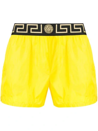 Shop Versace Greca Swim Shorts - Yellow