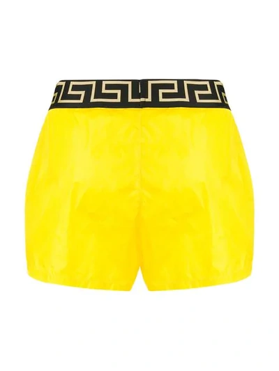 Shop Versace Greca Swim Shorts - Yellow