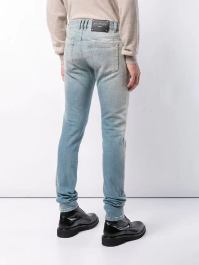 Shop Balmain Washed Out Jeans In Blue