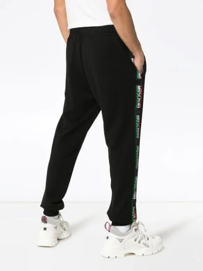 Shop Moschino Ticker Logo Embroidered Cotton Track Pants In Black