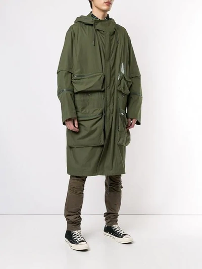 Shop Undercover Graphic Raincoat In Green