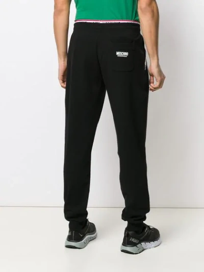 Shop Moschino Branded Track Pants In Black