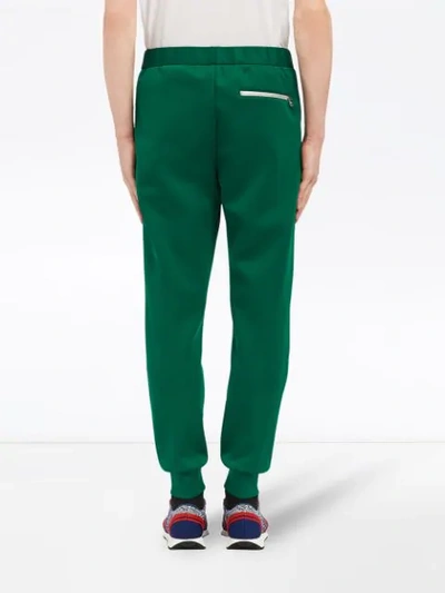 Shop Prada Technical Jersey Trousers In Green