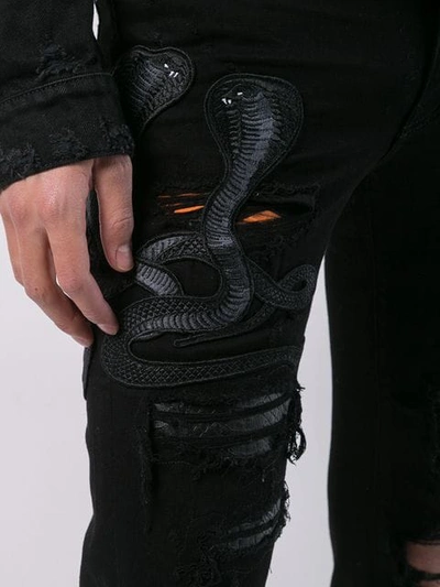 Amiri jeans snake best sale patch