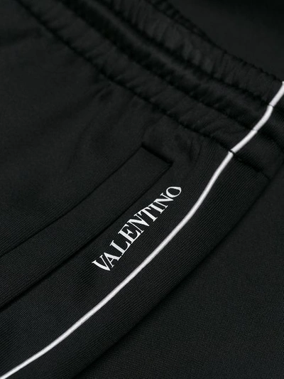 Shop Valentino Side Stripe Trousers In Black