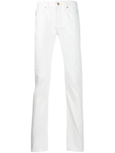 Shop Versace Straight-leg Jeans In White