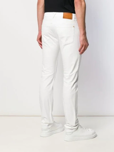 Shop Versace Straight-leg Jeans In White