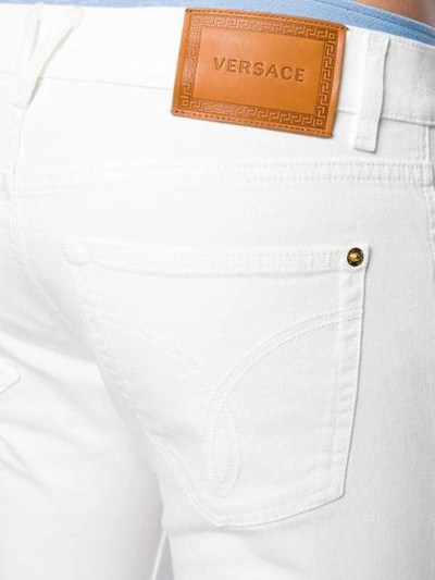 Shop Versace Straight-leg Jeans In White