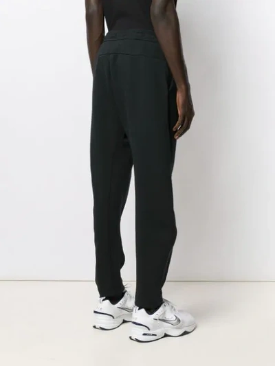 Shop Nike Baggy-fit Track Pants In Black