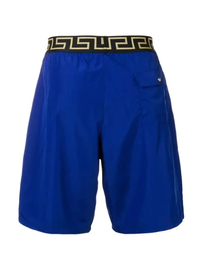 Shop Versace Printed Logo Swim Shorts In Blue