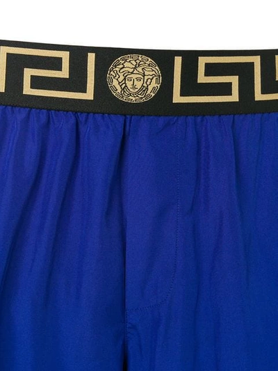 Shop Versace Printed Logo Swim Shorts In Blue