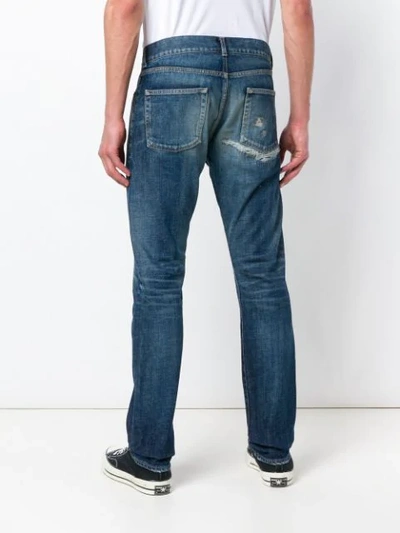 Shop Saint Laurent Distressed Mid-rise Straight Jeans In Blue