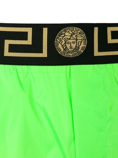 Shop Versace Logo Waist Swim Shorts In Green
