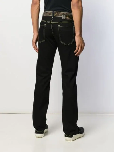 Shop Fendi Monogram Waistband Jeans In Black