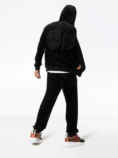 Shop Versace Logo Velour Sweatpants In Black