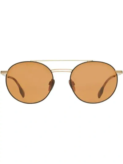 Shop Burberry Top Bar Detail Round Frame Sunglasses In Gold