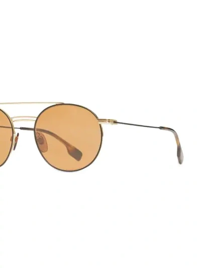 Shop Burberry Top Bar Detail Round Frame Sunglasses In Gold