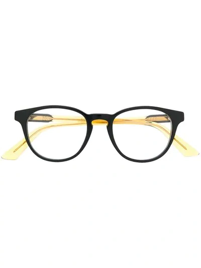 Shop Gucci Oval Frame Glasses In Yellow