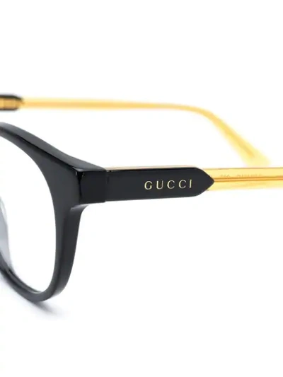 Shop Gucci Oval Frame Glasses In Yellow