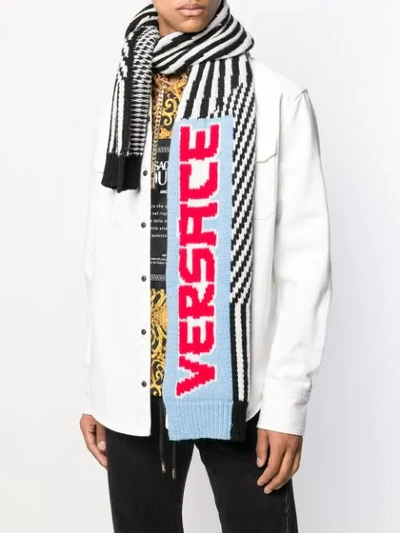 Shop Versace Striped Logo Knitted Scarf In Black