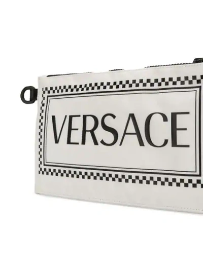 Shop Versace Clutch Mit Logo In Dwnxn Bianco+nero+nero