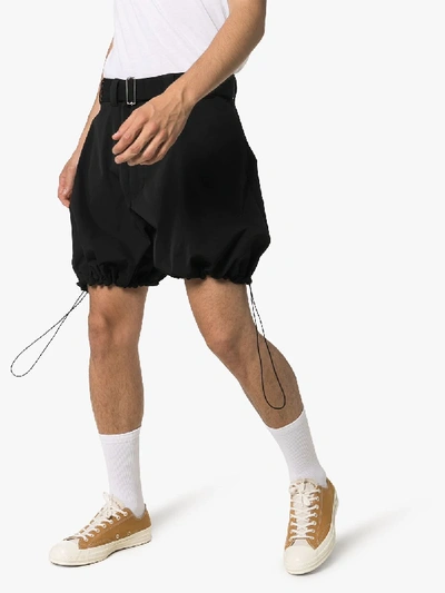 Shop Jw Anderson Drawstring Hem Voluminous Belted Shorts In 101 - Black