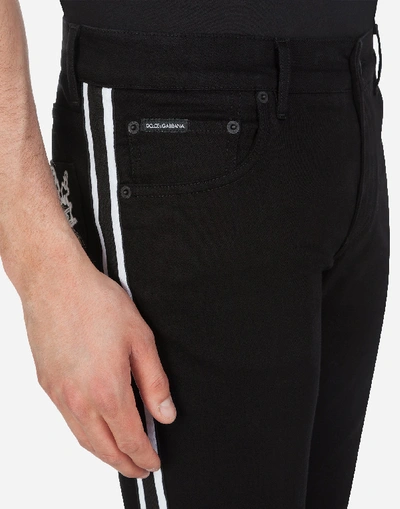 Shop Dolce & Gabbana Skinny Stretch Jeans With Dg Patch And Side Bands In Black