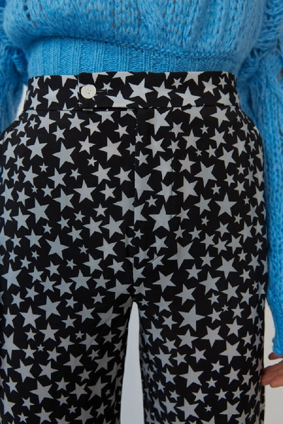 Shop Acne Studios Star-print Flared Trousers Black/grey