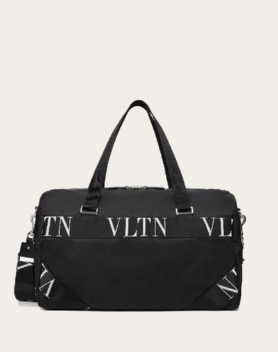 Shop Valentino Garavani Uomo Nylon Duffle Bag With Vltn Ribbon Handles In Black
