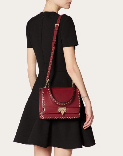 Shop Valentino Garavani Rockstud Smooth Calfskin Crossbody Bag In Cherry