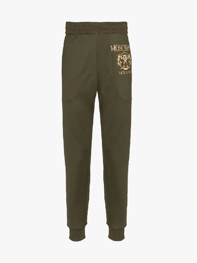 Shop Moschino Logo Track Pants In Green