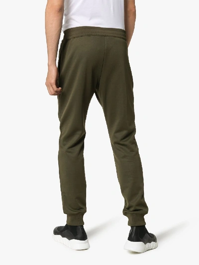 Shop Moschino Logo Track Pants In Green