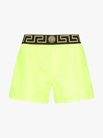 Shop Versace Logo Waist Swim Shorts In Yellow