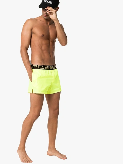 Shop Versace Logo Waist Swim Shorts In Yellow