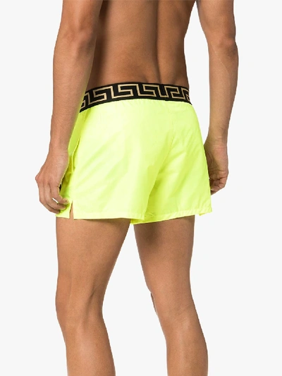 Shop Versace Logo Waist Swim Shorts In Yellow