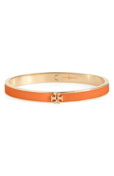 Shop Tory Burch Kira Logo Enamel Hinge Bracelet In Tory Gold / Orange