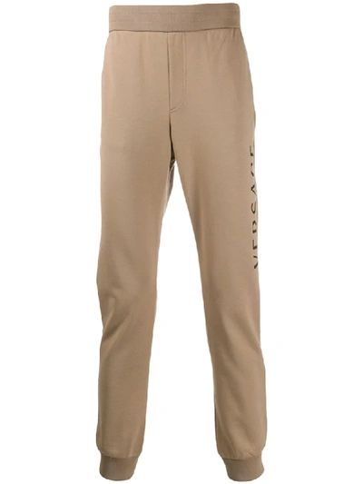 Shop Versace Logo Printed Track Pants In Neutrals