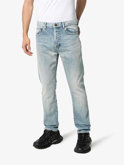 Shop Saint Laurent Straight Leg Frayed Hem Jeans In Blue