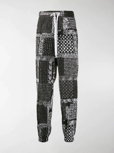 Shop Versace Bandana Print Trousers In Black