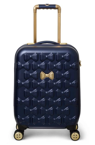 Shop Ted Baker Small Beau 22-inch Bow Embossed Four-wheel Trolley Suitcase In Navy