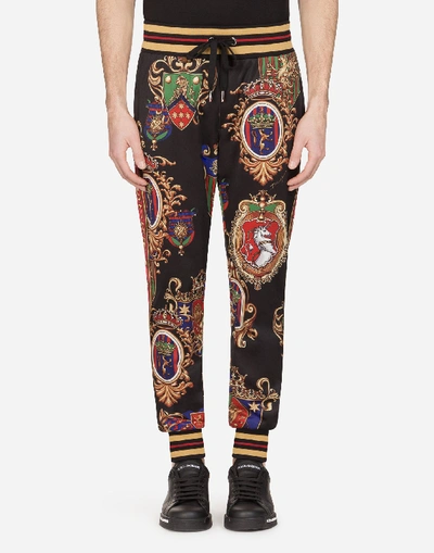 Shop Dolce & Gabbana Jersey Jogging Pants With Emblem Print And Bands In Black